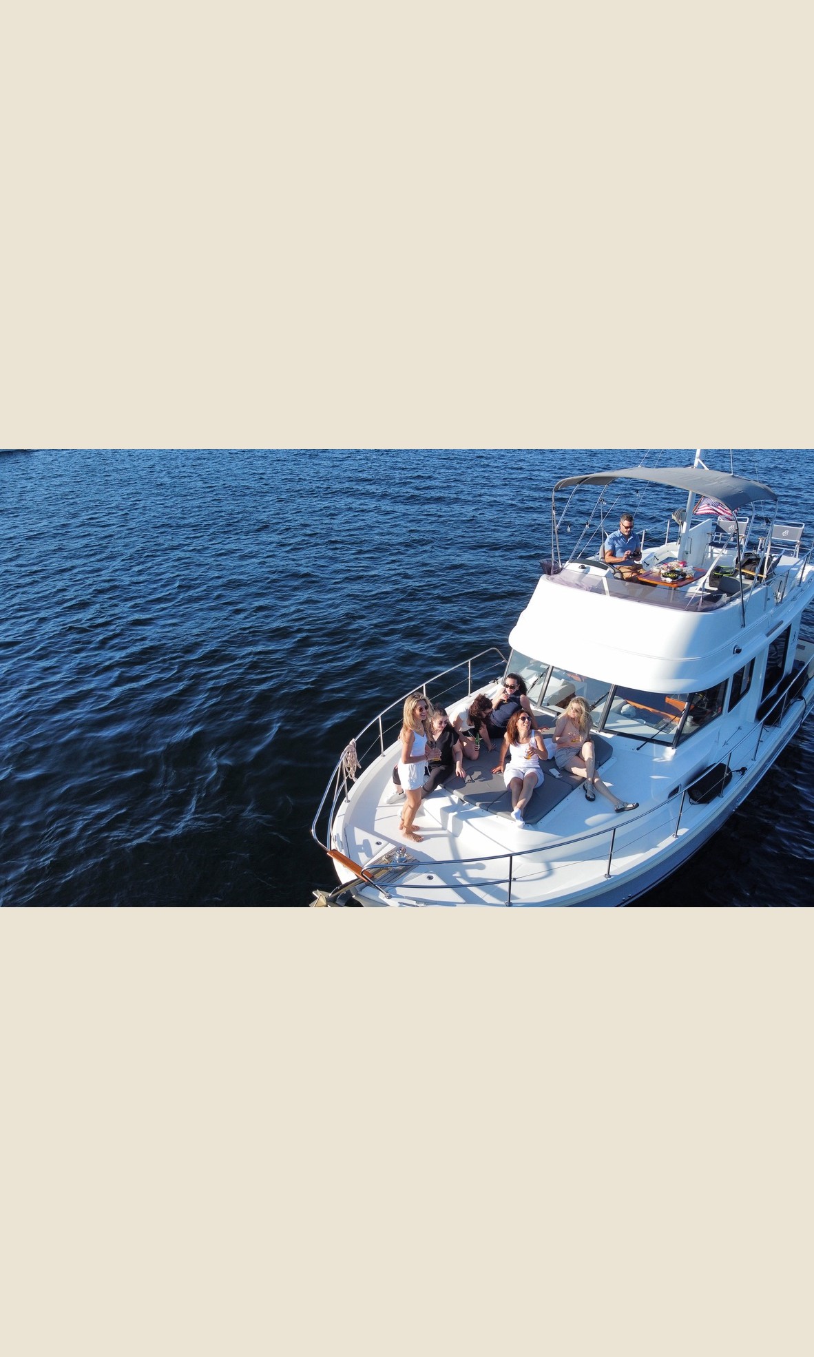 Aerial view of guests relaxing on the bow of the charter yacht on Lake Union